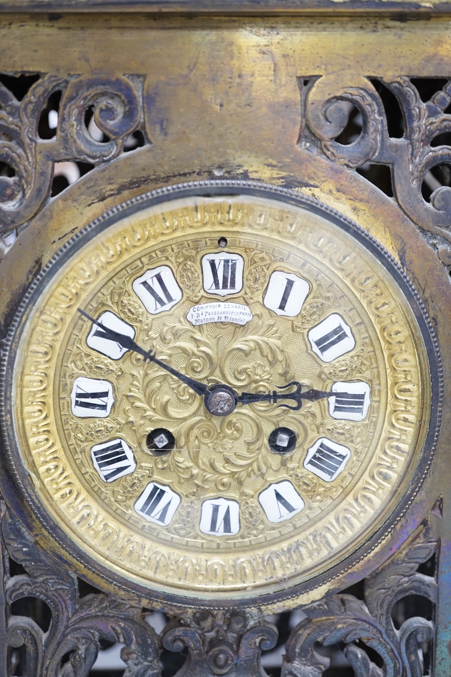 A French brass clock garniture, Comptoir General, 9 Bd Poissenniere, Paris, Maison H. Riondet on an enamel plaque to the dial. Height 42cm